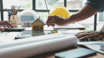 Image of team engineer checks construction blueprints on new project with engineering tools at desk in office. video