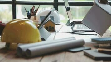 Image of team engineer checks construction blueprints on new project with engineering tools at desk in office. video