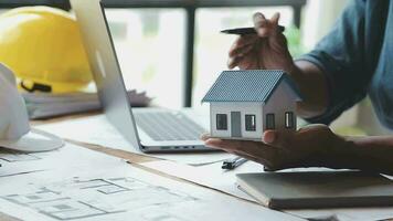 Image of team engineer checks construction blueprints on new project with engineering tools at desk in office. video