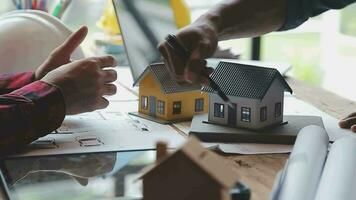 Image of team engineer checks construction blueprints on new project with engineering tools at desk in office. video