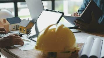 Image of team engineer checks construction blueprints on new project with engineering tools at desk in office. video