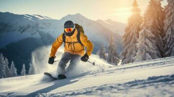 Man in ski goggles rides a snowboard from a snowy mountain photo