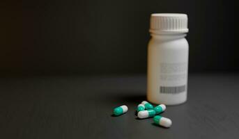 Pills on the table with bottle beside it on a black background, 3d illustration photo