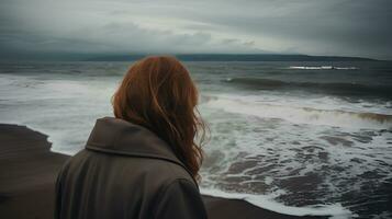 Woman alone and depressed at seaside photo