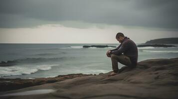 Man alone and depressed at seaside photo