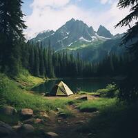 a tent is set up near a lake and mountains photo