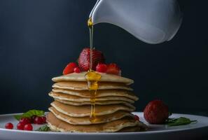 Pancake with strawberry and honey photo