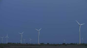 Wind turbines spinning against the blue sky video