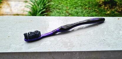 black toothbrush on grey wall photo