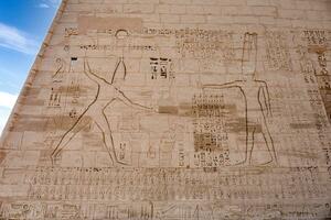 a large stone wall with hieroglyphics on it photo