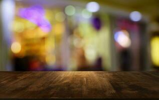 Empty wooden table in front of abstract blurred background of coffee shop . can be used for display or montage your products.Mock up for display of product. photo