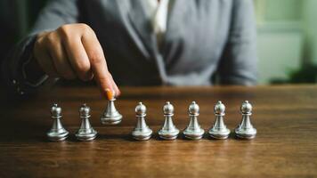 Human resources concept career management with clasped hands planning strategy with chess figures. HR department Search for employees by  inequality in the work collective photo