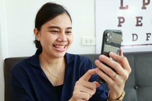 Person using phone, woman using mobile phone at home photo
