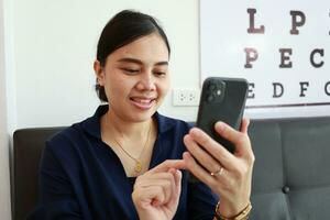 Person using phone, woman using mobile phone at home photo