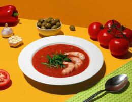 Summer cold soup gazpacho with srimps. Tomato and olives. Colourful photo