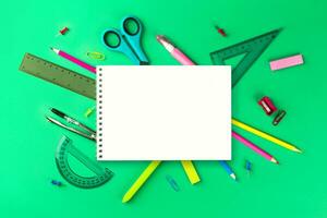 Flat lay composition with school supplies. composition with colorful stationery and whitenotebook, copy space. Back top school concept. Top view, overhead. photo