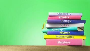School colourfull textbooks on the table. Basic school subjects mathematics, literature, physic,s chemistry, copy space photo