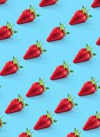 Ripe strawberries pattern. Food pattern. Blue background. Vertical photo