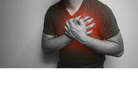 A close-up of a black and white hand in the chest with chest pain from a heart attack. Health care concept photo