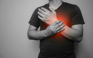 A black and white image Closeup of male arms holding his painful wrist  From arthritis symptoms photo