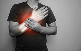 A black and white image of a man with a pain in his right wrist From arthritis symptoms photo