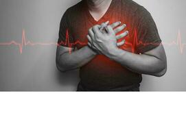 A close-up of a black and white hand in the chest with chest pain from a heart attack. Health care concept photo