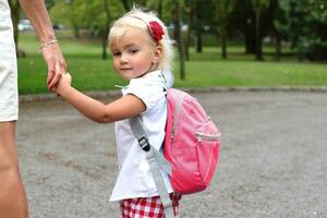 Little girl with backpack going to study, lifestyle staging photo