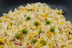 Cantonese Rice in a black dish. Close-up photo