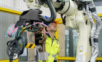 Engineer working and controlling robotics with monitoring system software automation robot arm.  AI, Artificial intelligence. photo
