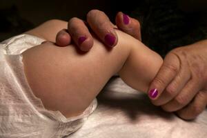 Masseur massaging little baby photo