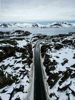 Road in the mountains with snow taken by drone photo