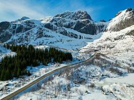 Road in the mountains with snow taken by drone photo