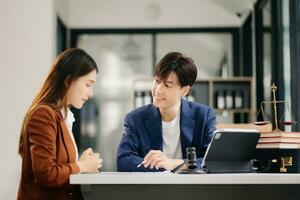 Business people compassionately holding hands and discussing contract papers with laptop and tabletat in office room. photo