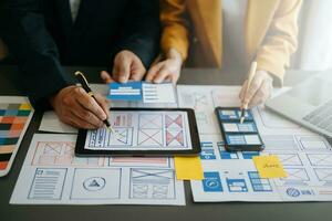 UX graphic designer planning application process development prototype wireframe for web smart phone. Creative digital development agency. photo