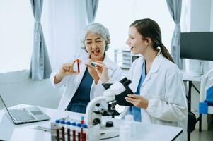 Scientist team meeting and writing analysis results in the laboratory study and analyze scientific sample, test samples photo