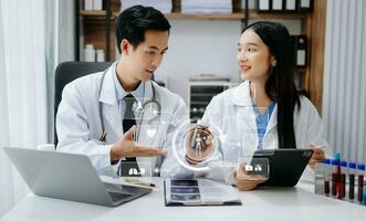Medical technology network team meeting concept. Doctor hand working with smart phone modern digital tablet and laptop computer with graphics chart interface, with virtual icon diagram photo