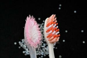 Compare new and old toothbrushes. that is still used every day, black background photo