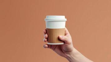 a person holding a coffee cup in their hand close up. photo