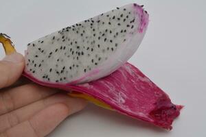 Dragon fruit, a fruit with many seeds, on a white background photo