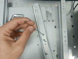 Tighten the stainless steel screws with a hex wrench. with left hand photo