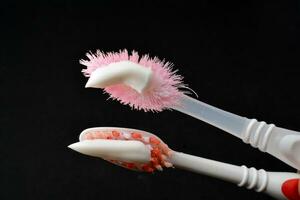 White toothpaste on a toothbrush. Black background photo