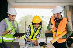 Engineers are discussing data working and laptop or tablet with architectural project at new construction site on big project. photo