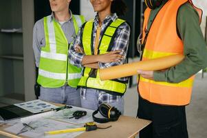 Engineers are discussing data working and laptop or tablet with architectural project at new construction site on big project. photo