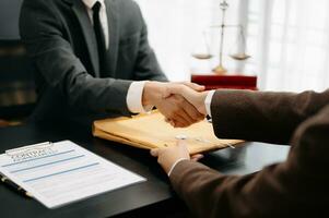 Consultation between a male lawyer and business customer, handshake after good deal agreement, Law and Legal concept.Good service cooperation photo