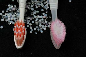 Compare new and old toothbrushes. that is still used every day, black background photo