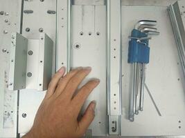 Tighten the stainless steel screws with a hex wrench. with left hand photo
