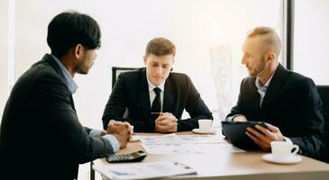 Business team discuss at meeting room. working together with laptop ,tablet and smart phone on desk Financial accountant , planner , meeting , introduction concept. At office photo