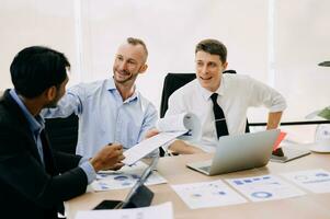 Office colleagues have a casual discussion. During a meeting in conference room, a group of business teem sit in the conference room new startup project photo