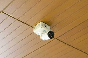 Security Camera, Old white have dusty CCTV on the wall in city or buildings and residences. photo