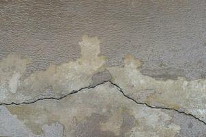 cracked brown concrete wall cement surface as background photo